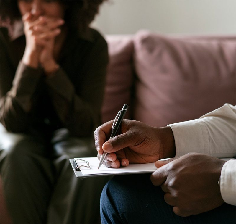 A therapist taking notes during a session
